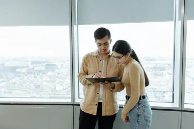 Two workers discussing the content on an iPad