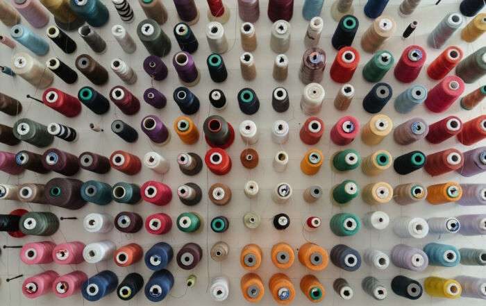 cotton spools of various colours representing transformative inclusivity
